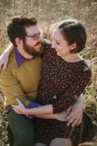 couple embracing in a field