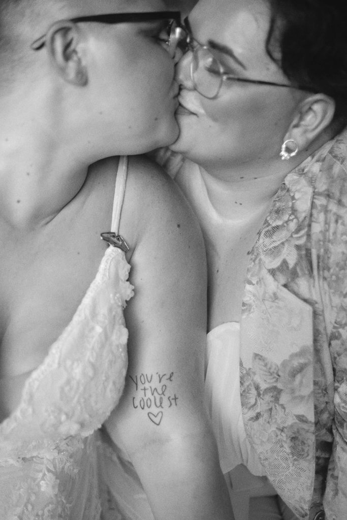 brides kissing queer wedding